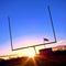 American Football Goal Posts and US Flag at Sunset