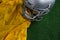 American football head gear and jersey lying on artificial turf