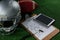 American football head gear, tablet, whistle and football on artificial turf