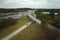 American freeway intersection with fast driving cars and trucks. View from above of USA transportation infrastructure