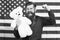 American guy with toy celebrate holiday. American holiday. Man bearded hipster hold teddy bear american flag background