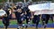 American High School football team enters field