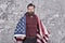 American hipster man celebrate independence day with national flag, cultural identity concept