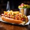 an american hot dog with a portion of french fries blurred restaurant in the background