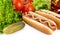 American hotdogs with cola,pickled cucumber,salad,tomatoes on white