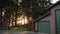 American house in the countryside on sunset, cozy corner beside forest, garden