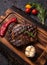 American juicy steak on the board with spices, tomato and grilled vegetables