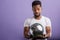 American man holding shining disko ball