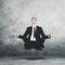 American manager levitating during doing meditation