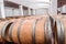 American oak barrels with red wine. Traditional wine cellar