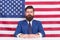 American patriotism. American citizen in formalwear. Bearded man on american flag background. Independence day. July 4th