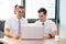 American people business two young caucasian modern man sitting in a meeting room using and looking laptop together.