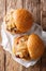 American pork chop sandwiches with onions and mustard close-up on paper. Vertical top view