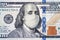 American President with face mask against CoV infection. 100 dollar banknote. Coronavirus in United States. Concept quarantine and