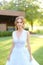 American pretty bride standing in garden.