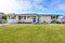 American rambler exterior with grass filled garden.