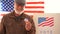 American retired masked to vote in 2020 US elections in the voting booth. An elderly man with glasses and a gray beard