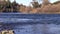 American River Flowing With Rocks In Foreground