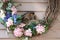 American robin chicks in wreath nest being fed