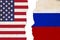 American and Russian flags that are torn apart