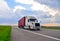 American semi truck transporting sea container on highway on sunset background. Shipping Containers Delivery, Maritime Services