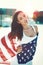 American sensual beauty covered by star spangled banner in sunset