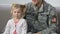 American serviceman hugging cute daughter holding national flag, patriotism