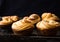 American shortbread cookies with chocolate drops and a jug of milk and almonds. Dark grunge background. Mystical light