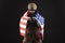 American special forces against a dark background, a soldier in military equipment holds weapons and the flag of the United States