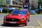 American sports car red Ford Mustang with the emblem horse on the hood is standing on a street in the Hungarian city. Budapest,