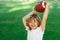 American style football. Kids and sports. Young boy playing american football. Child holding rugby ball while playing