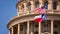 American and Texas Flags Flying at the Texas State Capitol Building in Austin