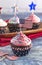 American Themed Cupcakes with Flags on a Wooden Table