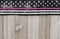 American thin pink line flag over weathered wood background