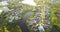 American waterfront houses in rural US suburbs at sunset. View from above of large residential homes in small town in