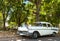 American white 1957 vintage car parked in the shadow under a tree in Havana City Cuba - Serie