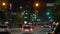 American wide multilane street intersection with traffic lights and moving cars at night. Transportation system in USA