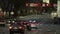 American wide multilane street intersection with traffic lights and moving cars at night. Transportation system in USA