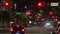 American wide multilane street intersection with traffic lights and moving cars at night. Transportation system in USA