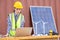 American women engineer and caucasian electrician wearing yellow  hard hat working on laptop computer