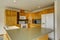 American wooden corner kitchen with gray counter tops.