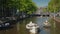 Amesterdam, Netherlands, May 2018: A boat decorated with flowers floats along the canal in Amsterdam. Tourism in a