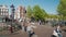 Amesterdam, Netherlands, May 2018: Scenic intersection with a bridge with heavy traffic of bicycles.