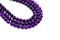 Amethyst bead strands on white background. Purple or violet crystal stone.