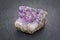 Amethyst cluster on gray slate stone