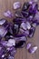 Amethyst heap up stones texture on brown varnished wood background