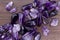 Amethyst heap up stones texture on brown varnished wood background