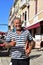 Amiable smiling Gondolier in Venice with tattoo and hat