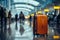 Amid the airport\\\'s commotion, a luggage bag blends into the blurred setting