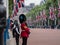 Amid tight security, Royal Guards in red and black uniform and bearskins line The Mall in London for Trooping the Colour Parade